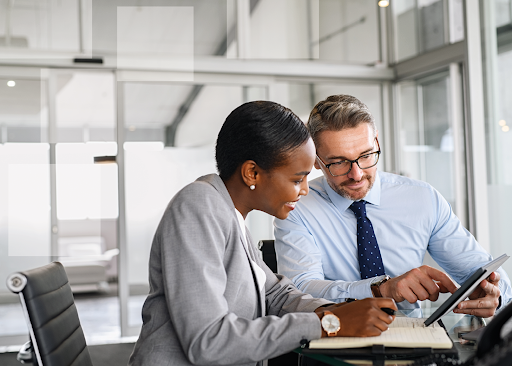 Financial advisor reviewing financial documents with a customer, representing strategies for keeping credit utilization low.